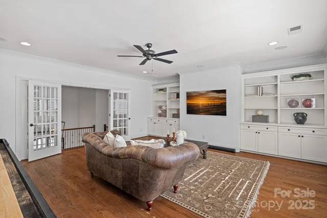 a bedroom with a bed a window and a flat screen tv