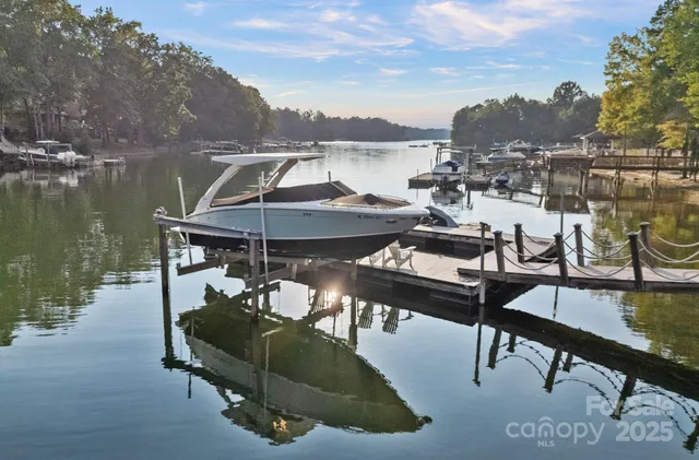 a front view of a house with a garden and trees