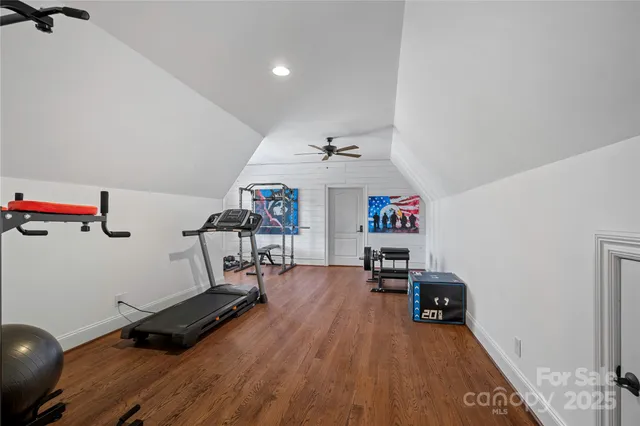 a backyard of a house with fountain table and chairs