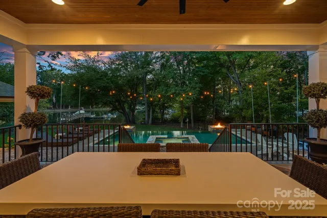 a view of a patio with couches table and chairs and potted plants