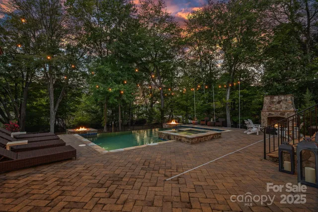 a view of a lake with table and chairs