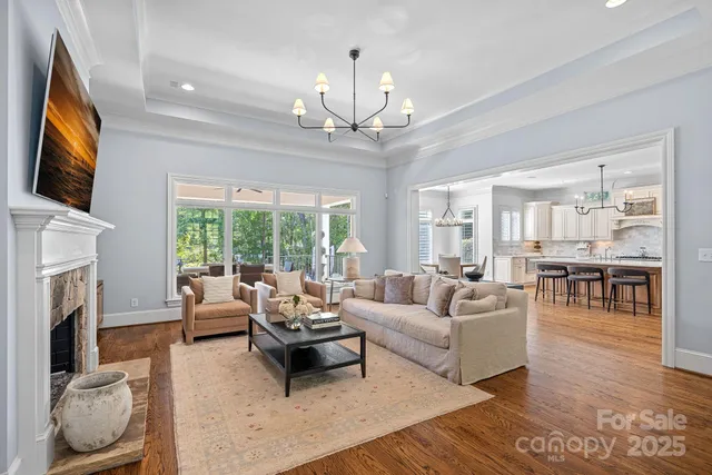 a view of living room with kitchen island furniture and a fireplace