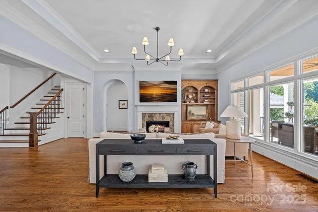 a kitchen with kitchen island a dining table chairs stainless steel appliances and cabinets