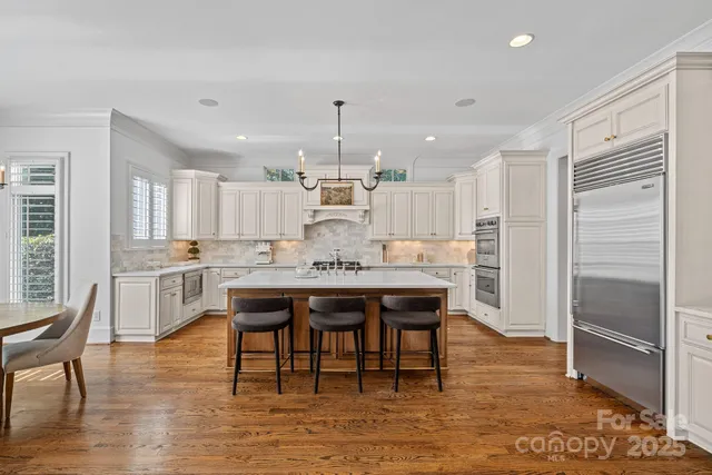 a kitchen with center island table and chairs