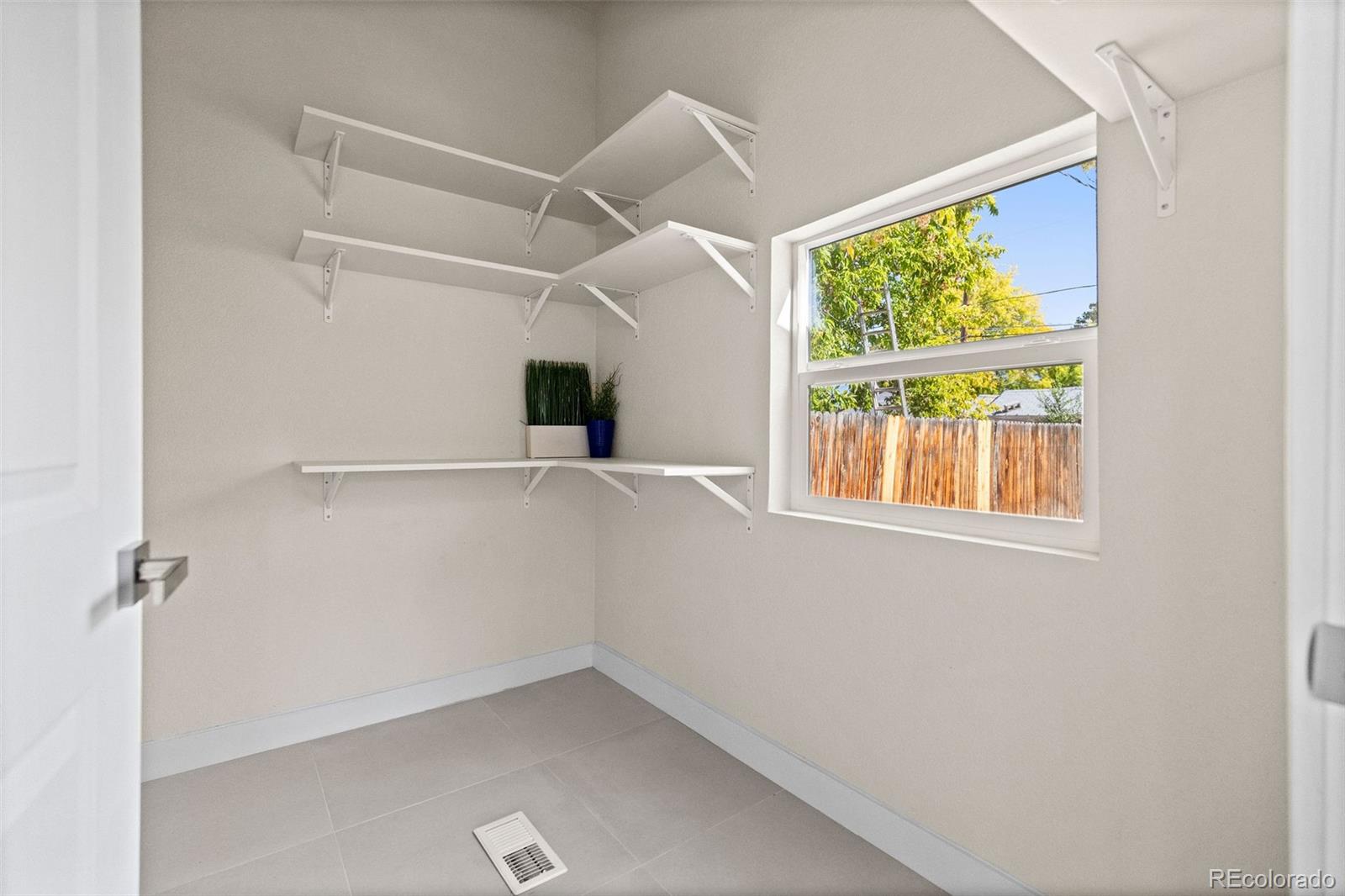 146 Stuart Street Denver, CO 80219 - Photo 21 of 31 an empty room with windows