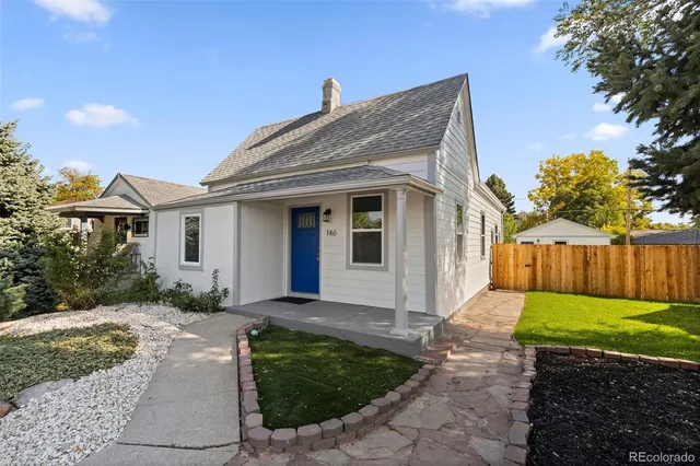 a front view of house with a garden