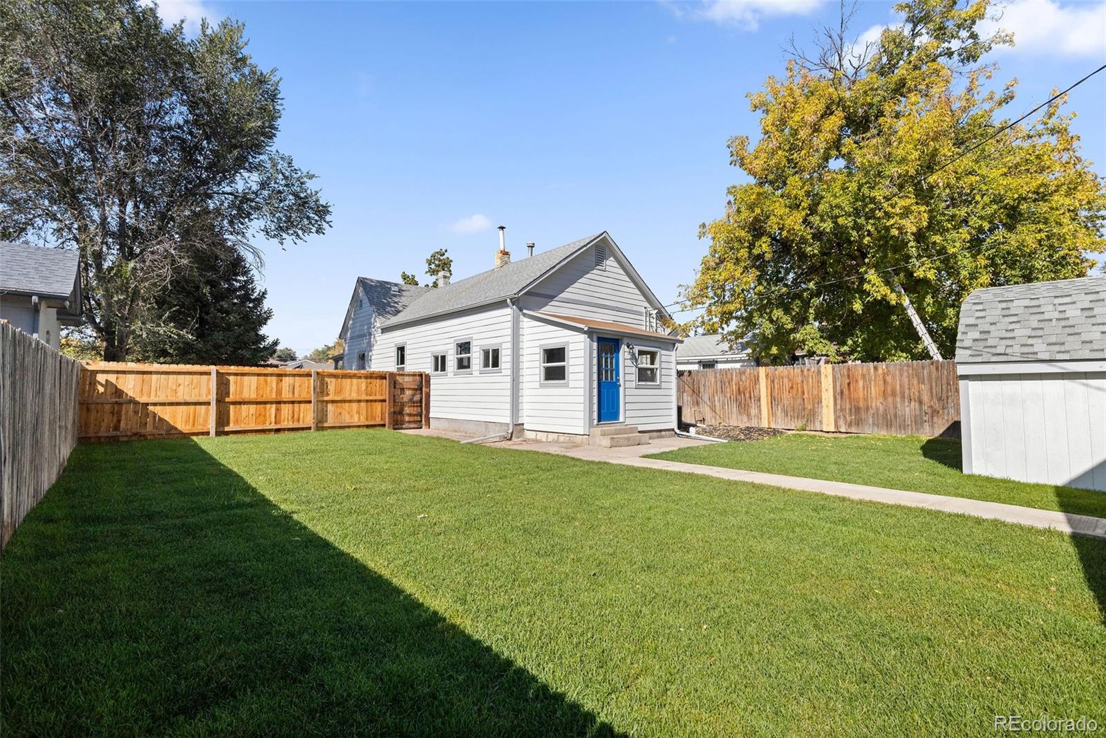 146 Stuart Street Denver, CO 80219 - Photo 24 of 29 a front view of a house with a yard