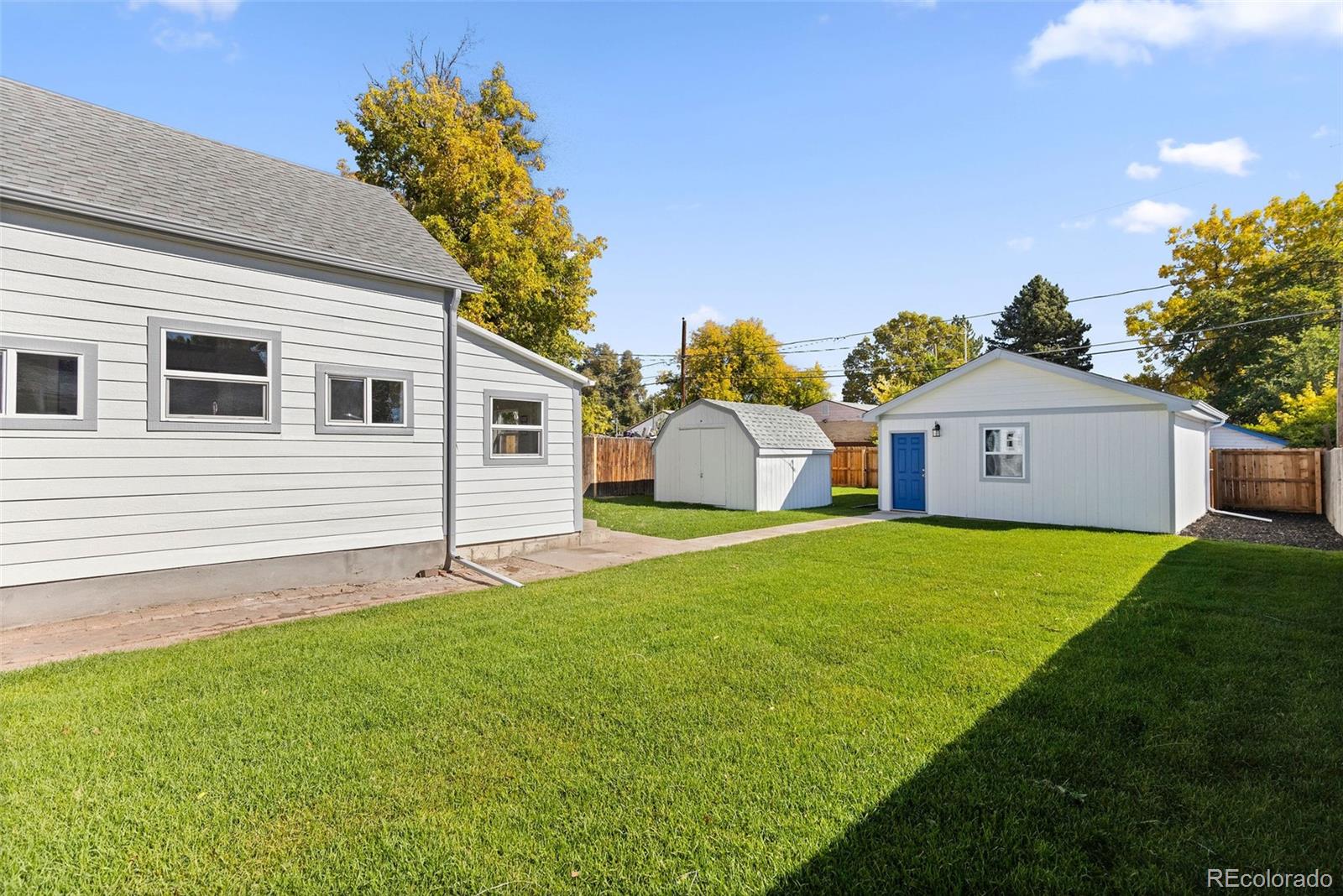 146 Stuart Street Denver, CO 80219 - Photo 25 of 31 a front view of a house with a yard and garage