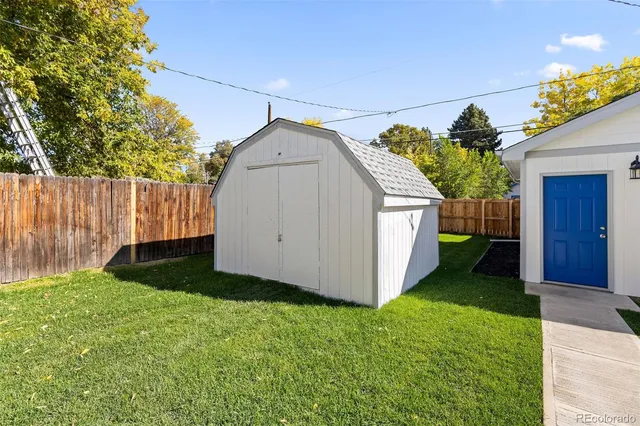 a view of a backyard with a cabin and plants