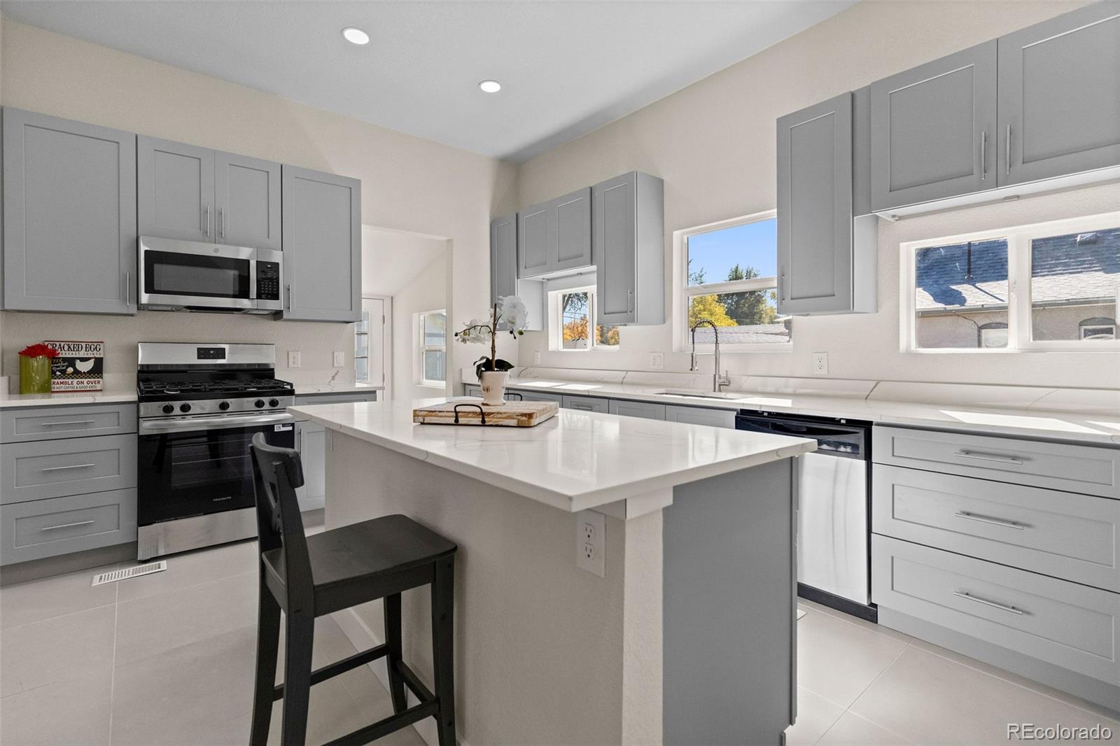 146 Stuart Street Denver, CO 80219 - Photo 3 of 31 a kitchen with appliances a sink and cabinets