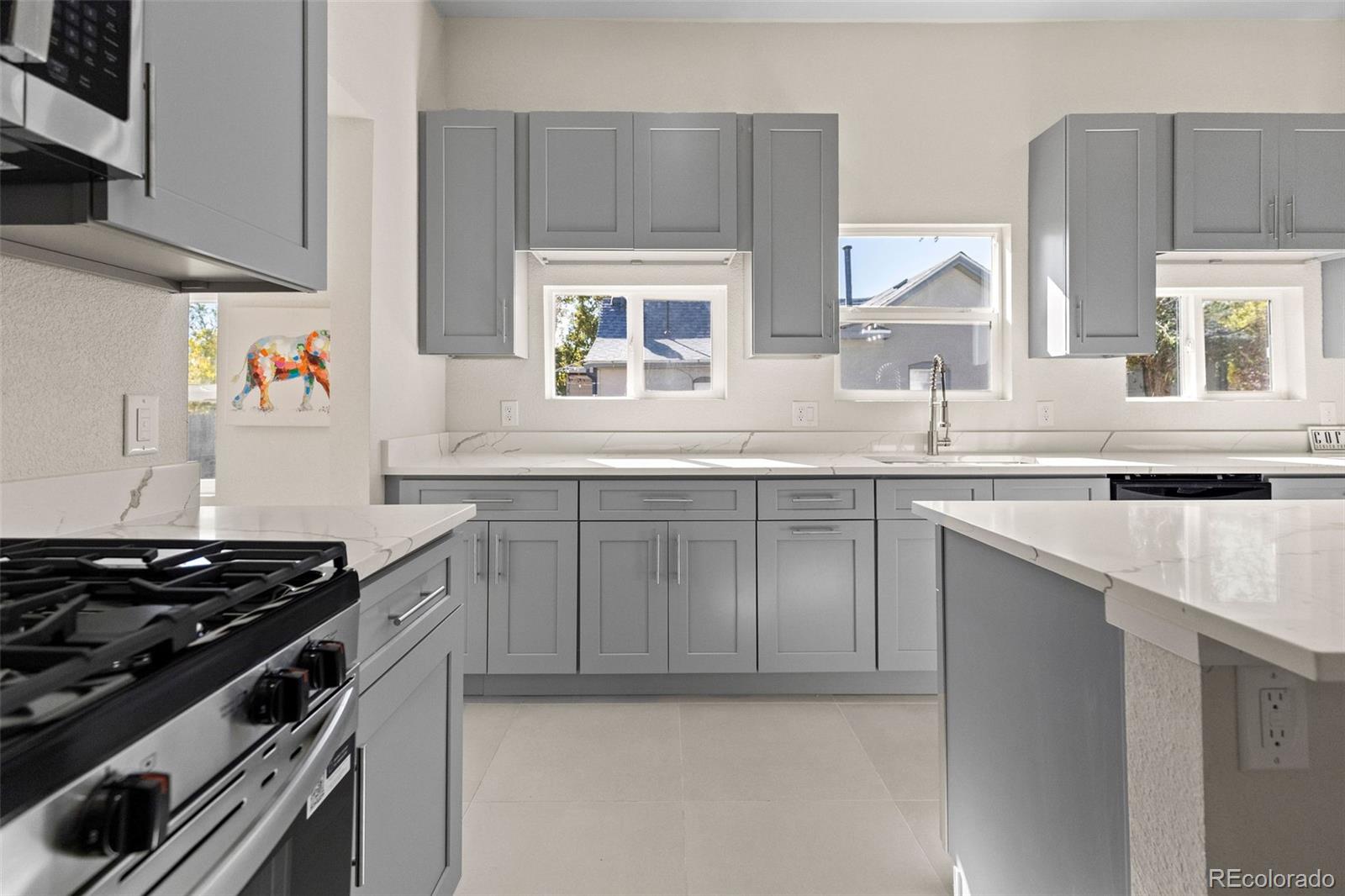 146 Stuart Street Denver, CO 80219 - Photo 6 of 31 a kitchen with stainless steel appliances a sink stove and cabinets