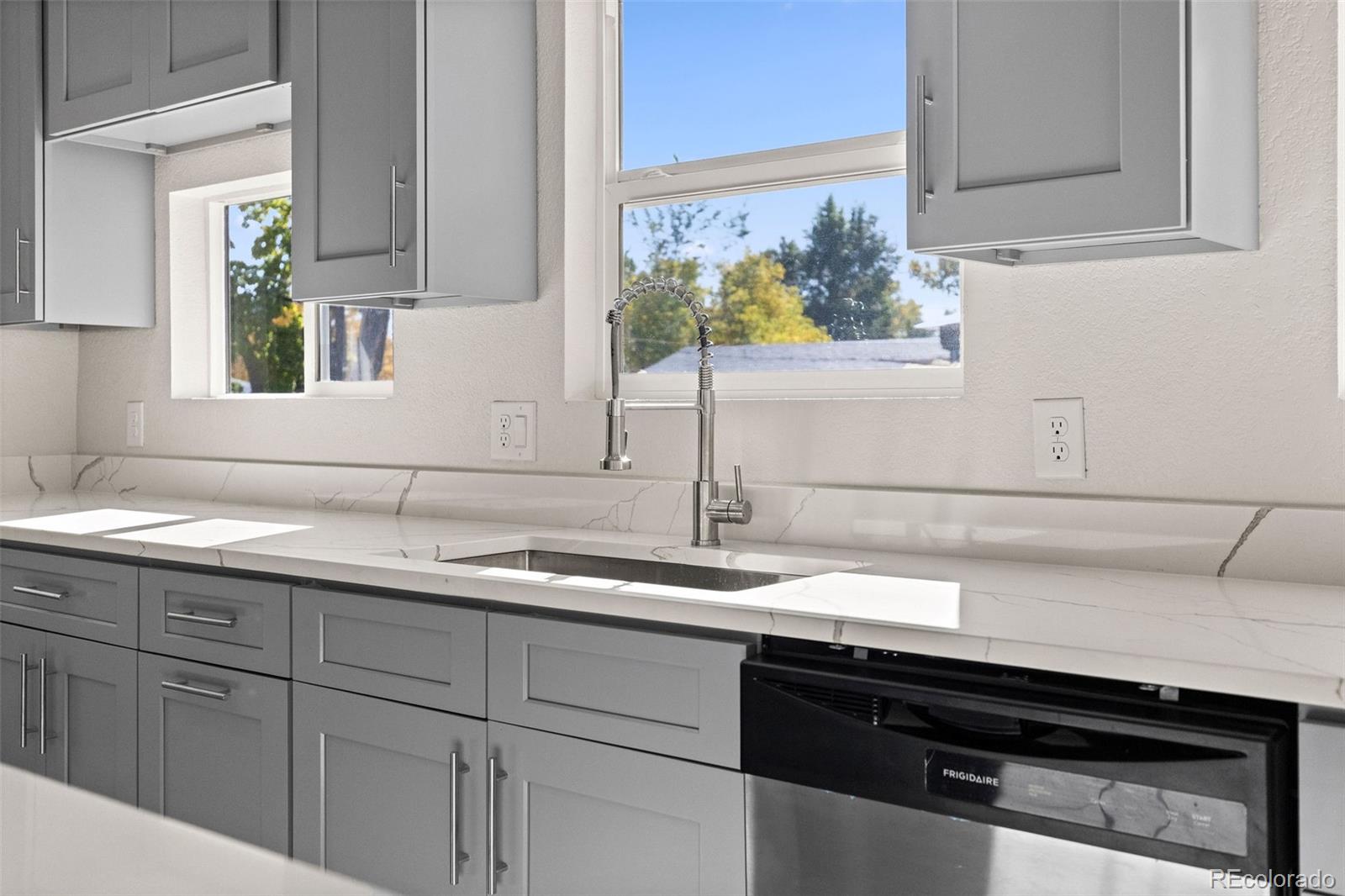 146 Stuart Street Denver, CO 80219 - Photo 7 of 31 a kitchen with a sink and cabinets