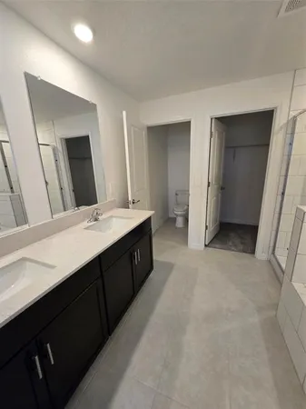 a bathroom with a double vanity sink a and mirror