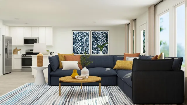 a living room with furniture and kitchen view