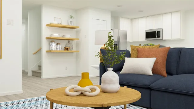 a living room with furniture and a wooden floor