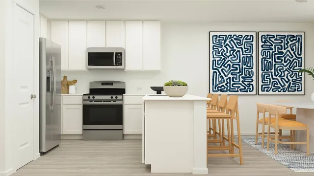 a kitchen with kitchen island cabinets and chair