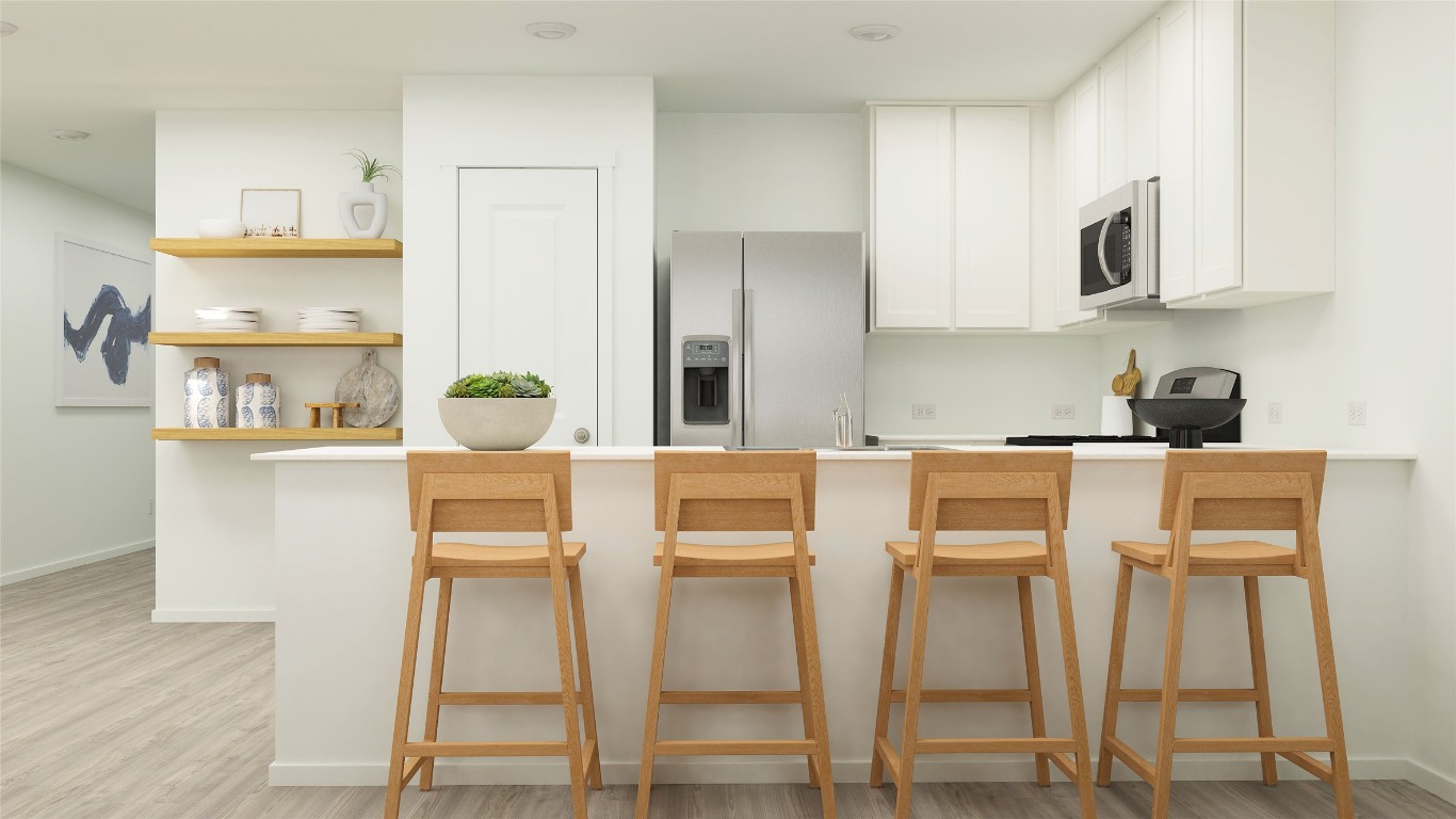 429 Silvercloud Drive Lockhart, TX 78644 - Photo 26 of 37 a kitchen with kitchen island cabinets and chair