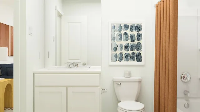 a bathroom with a toilet and a shower curtain