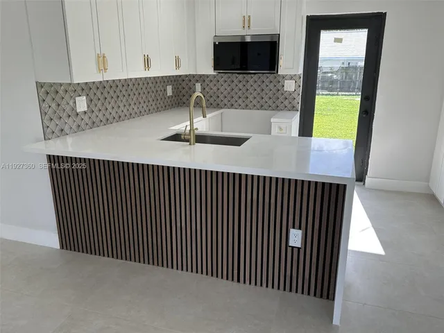 a kitchen with a sink and cabinets