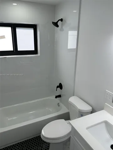 a white toilet sitting next to a bath tub