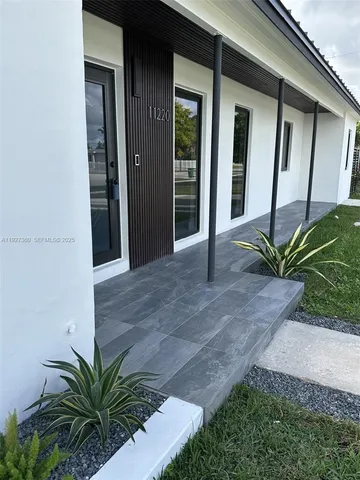 a potted plant in front of a glass door