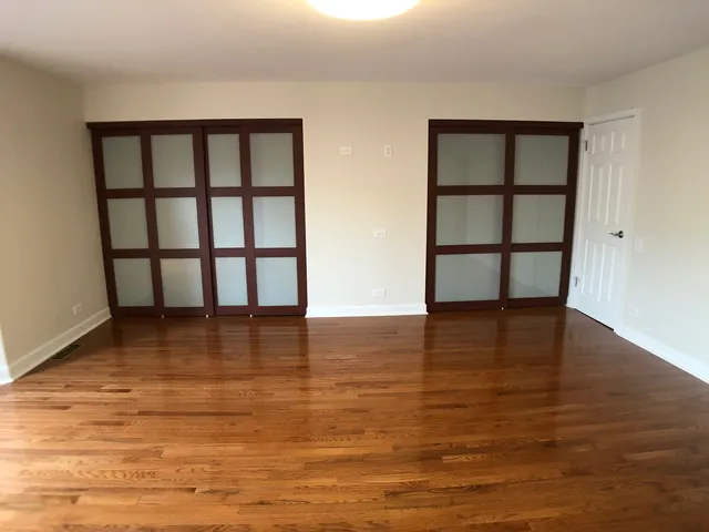 a view of a room with window and wooden floor