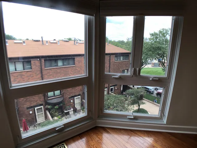 a view of a window with brick walls