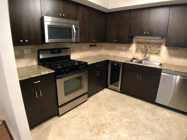 a kitchen with a stove a sink and a microwave