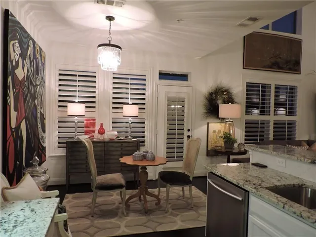 a dining room with furniture and a flat screen tv