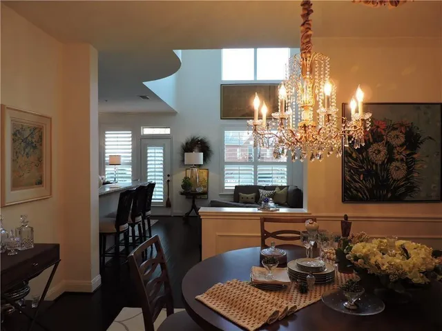 a room with furniture a chandelier and a window
