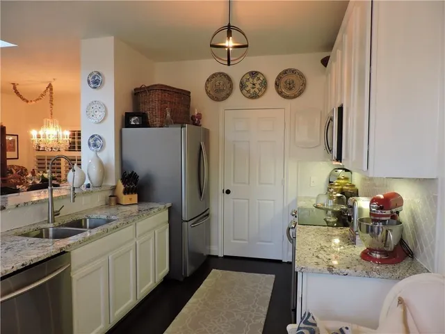 a bathroom with a sink a mirror and cabinets