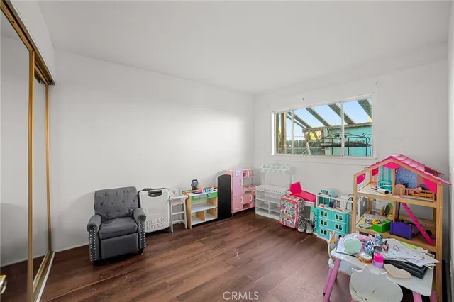 a kids room with toys and a wooden floor