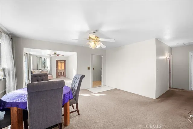a view of a dining room with furniture and a chandelier
