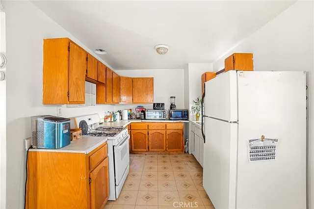 a kitchen with a refrigerator a stove top oven a sink and dishwasher