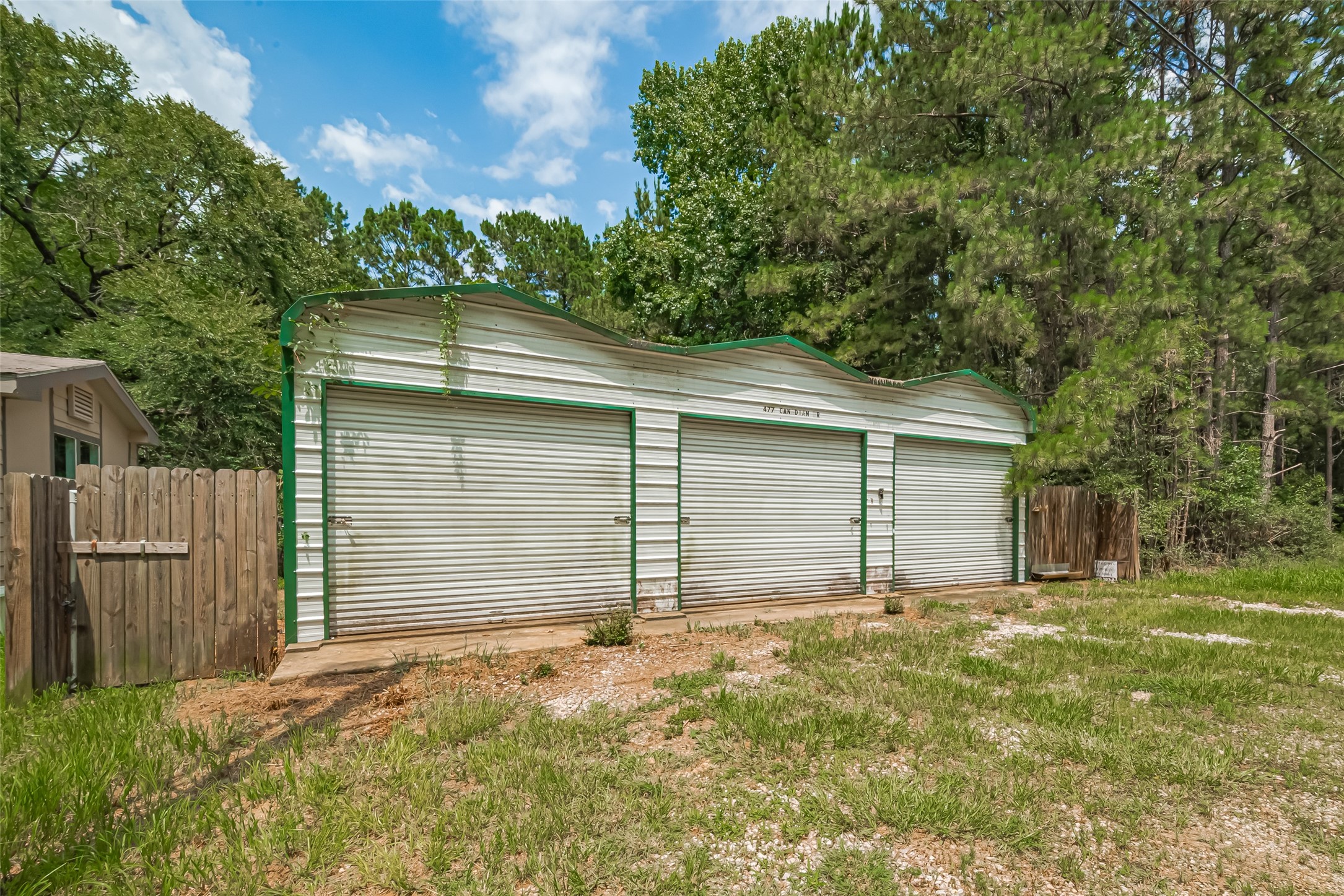 477 Canadian Drive Trinity, TX 75862 - Photo 7 of 11 a backyard of house with a garage