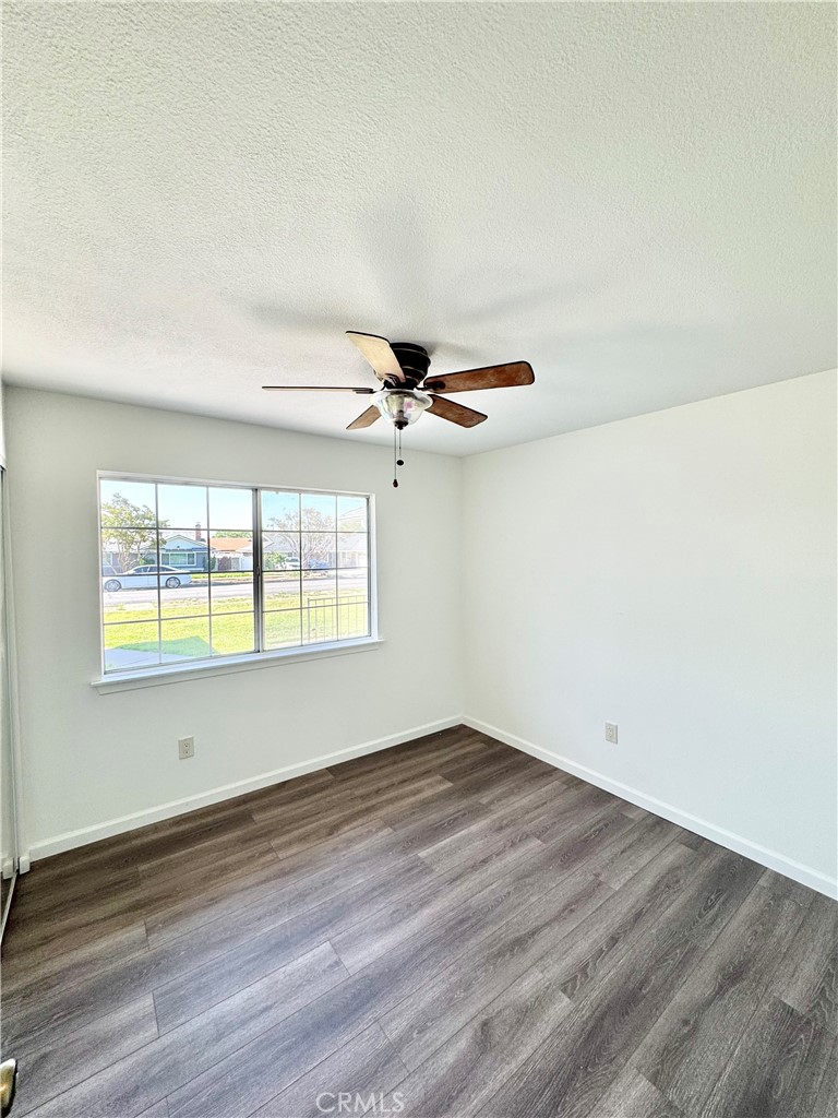 9364 Langston Street Rancho Cucamonga, CA 91730 - Photo 11 of 17 an empty room with wooden floor and windows