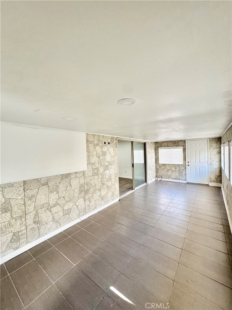 9364 Langston Street Rancho Cucamonga, CA 91730 - Photo 13 of 17 a view of an empty room with wooden floor and a window