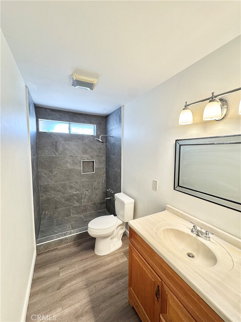 9364 Langston Street Rancho Cucamonga, CA 91730 - Photo 7 of 17 a bathroom with a sink a toilet and shower