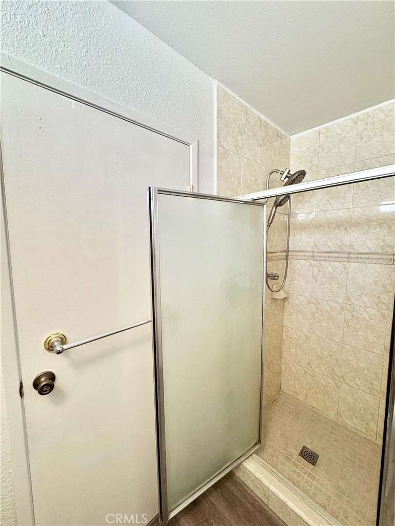 9364 Langston Street Rancho Cucamonga, CA 91730 - Photo 10 of 17 a bathroom with a glass shower door