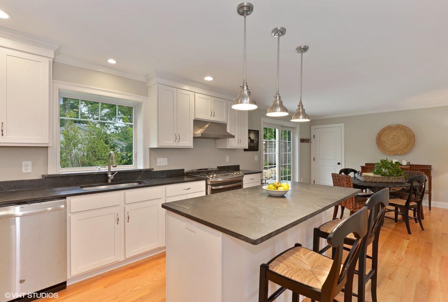 18 Darby Way Osterville, MA 02655 - Photo 4 of 15 a kitchen with a table chairs stove and microwave