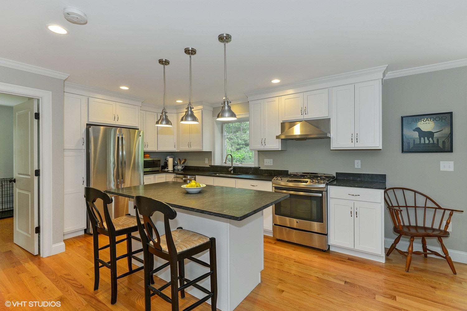 18 Darby Way Osterville, MA 02655 - Photo 5 of 15 a kitchen with stainless steel appliances granite countertop a sink a stove a refrigerator and island with wooden floor