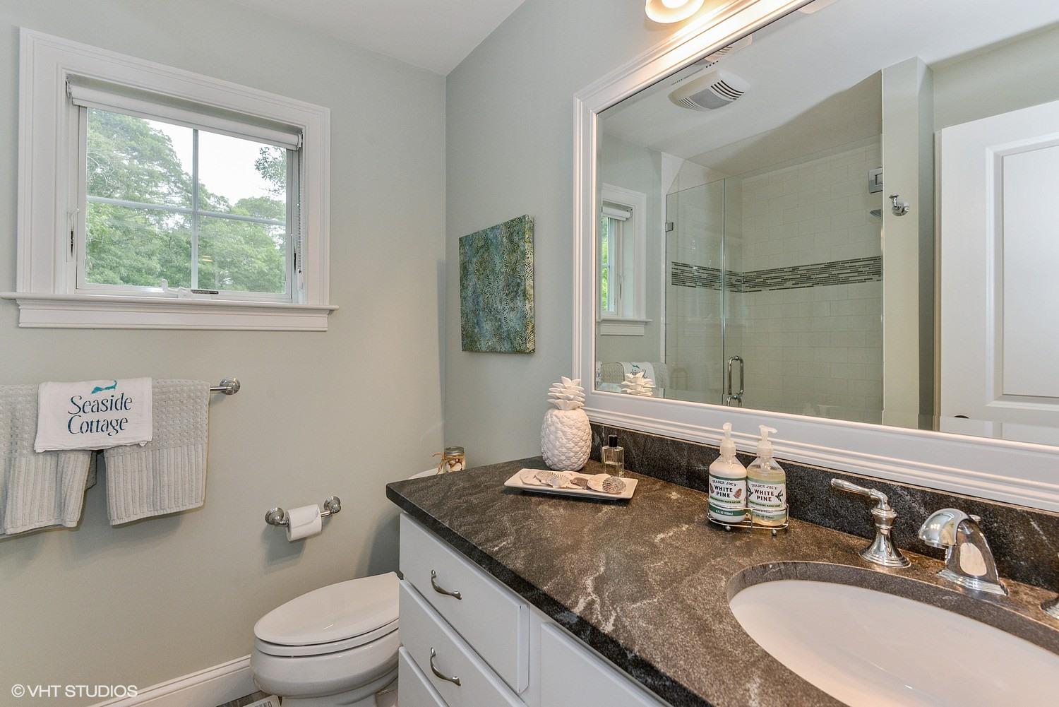 18 Darby Way Osterville, MA 02655 - Photo 9 of 15 a bathroom with a granite countertop sink a large mirror and a window