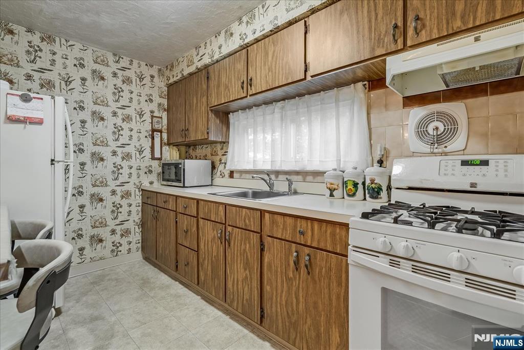 29 Lynwood Road Verona, NJ 07044 - Photo 11 of 39 a kitchen with stainless steel appliances a stove a sink and a refrigerator