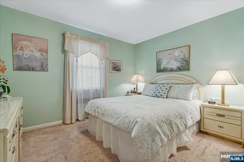 a bedroom with a bed and a painting on the wall
