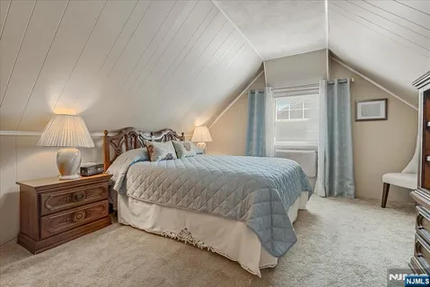 a bedroom with a bed and a lamp on wall