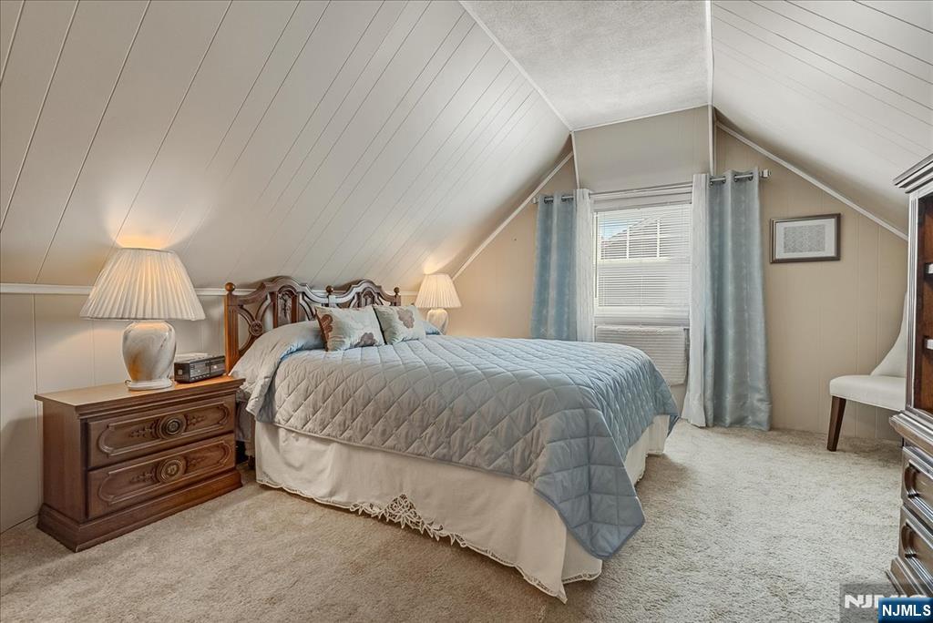 29 Lynwood Road Verona, NJ 07044 - Photo 16 of 39 a bedroom with a bed and a lamp on wall