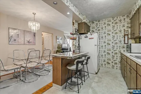 a dining room with furniture and chandelier