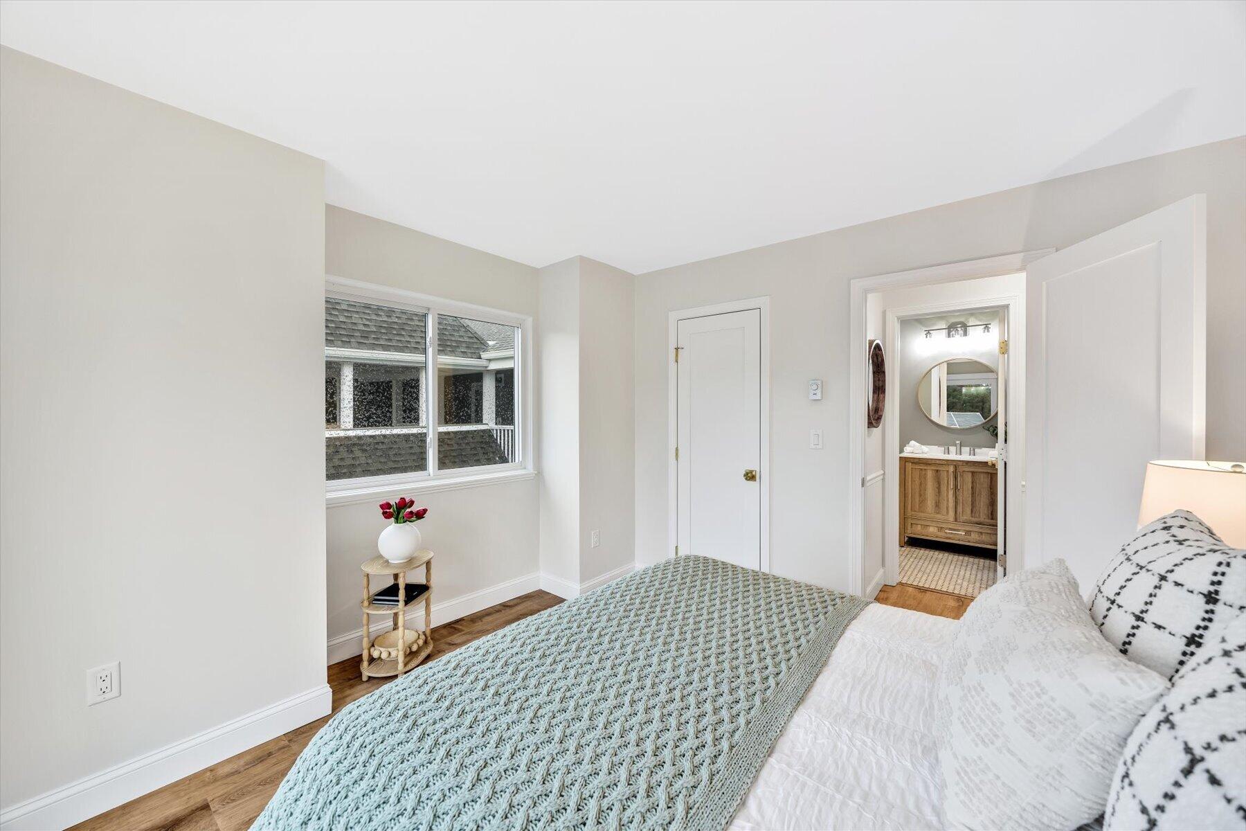 62 Fletcher Lane, Unit G Brewster, MA 02631 - Photo 14 of 30 a bedroom with a bed and wooden floor