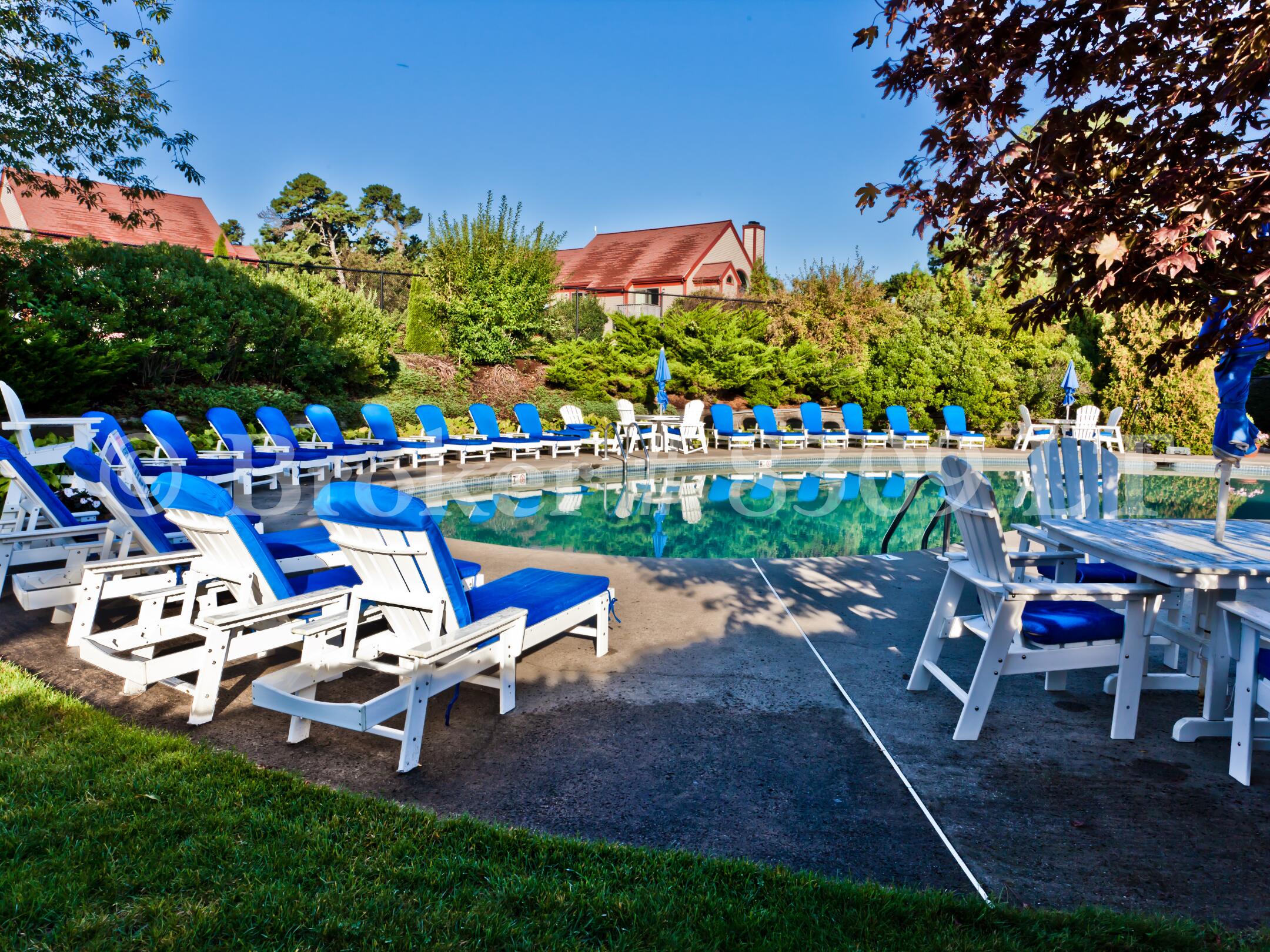 62 Fletcher Lane, Unit G Brewster, MA 02631 - Photo 24 of 30 a view of a chairs and tables in the backyard