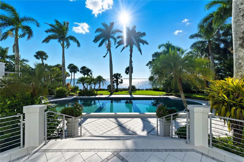 3315 Bay Shore Road Sarasota, FL 34234 - Photo 77 of 96 a view of swimming pool with a table and chairs